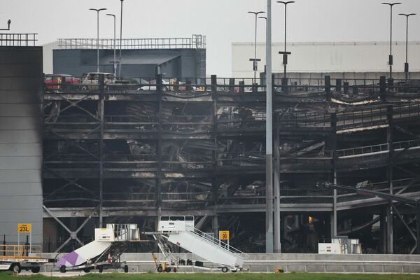 Ugunsgrēka radītie postījumi Lūtonas lidostas autostāvvietā Londonā. Foto: HENRY NICHOLLS / AFP