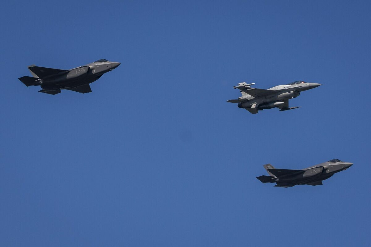 Divi F-35 iznīcinātāji un F-16 lidaparāts pa vidu. Foto: Wojtek RADWANSKI / AFP / Scanpix
